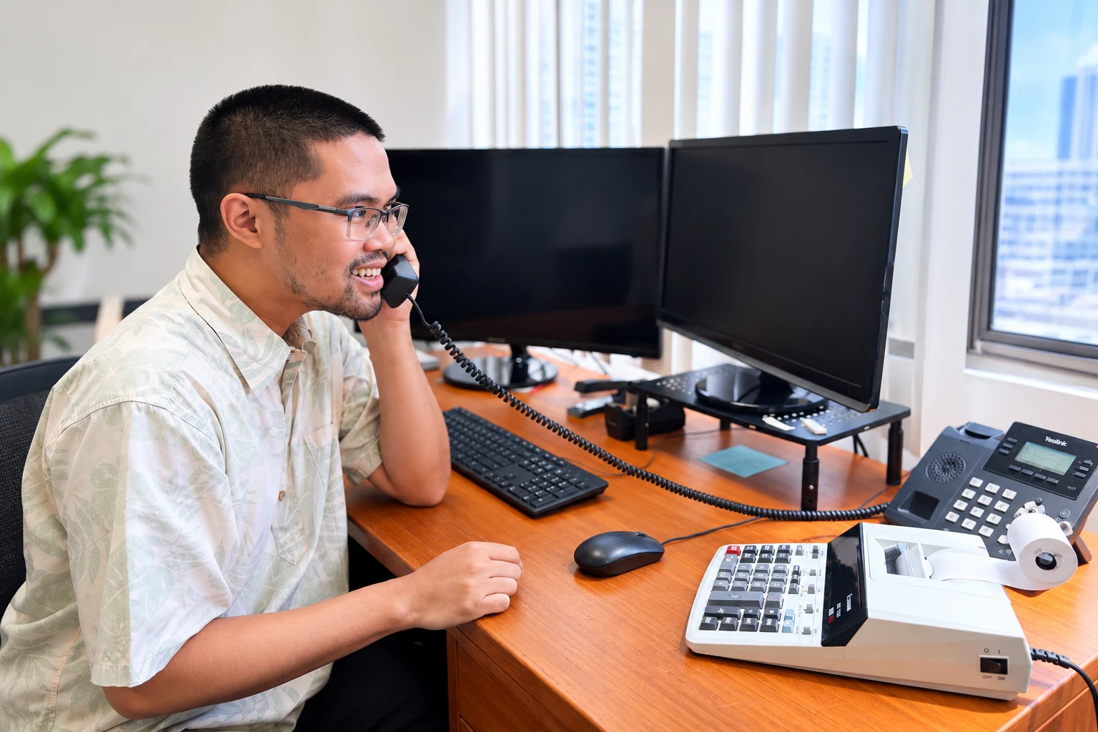 SMTA advisor at his desk on a call, reviewing figures